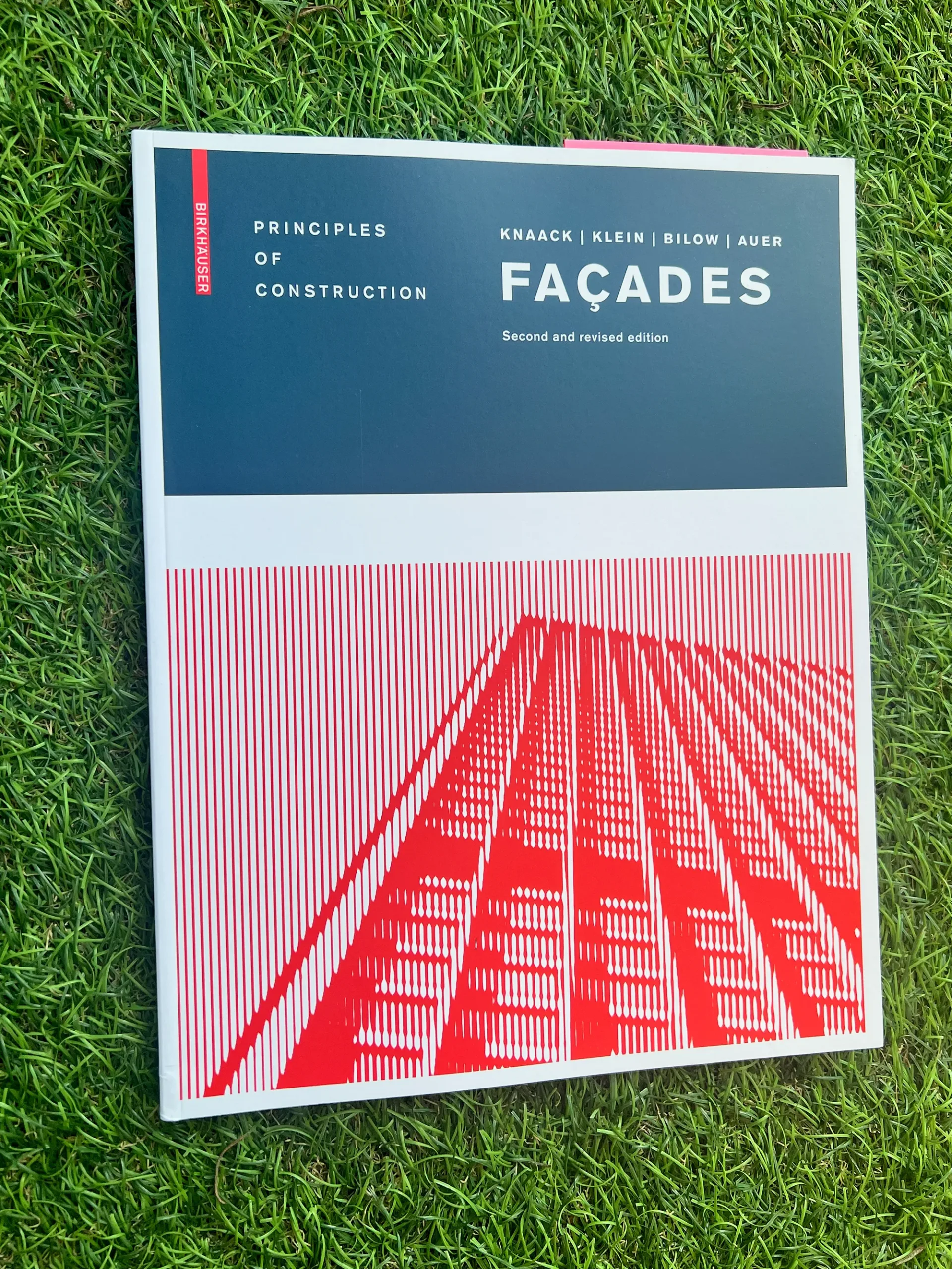 Picture of facade construction and architectural design reference book on green grass turf