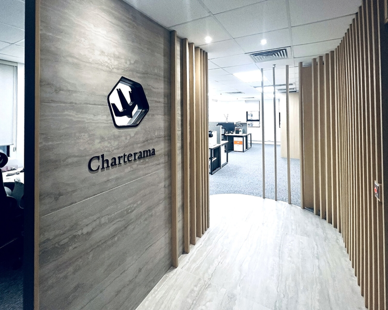Charterama Office Renovation with tile, wood louvers and stainless steel signage