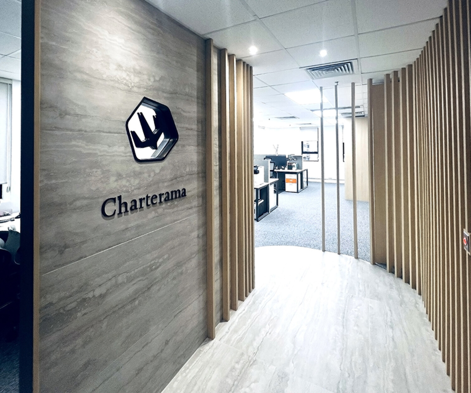 Charterama Office Renovation with tile, wood louvers and stainless steel signage